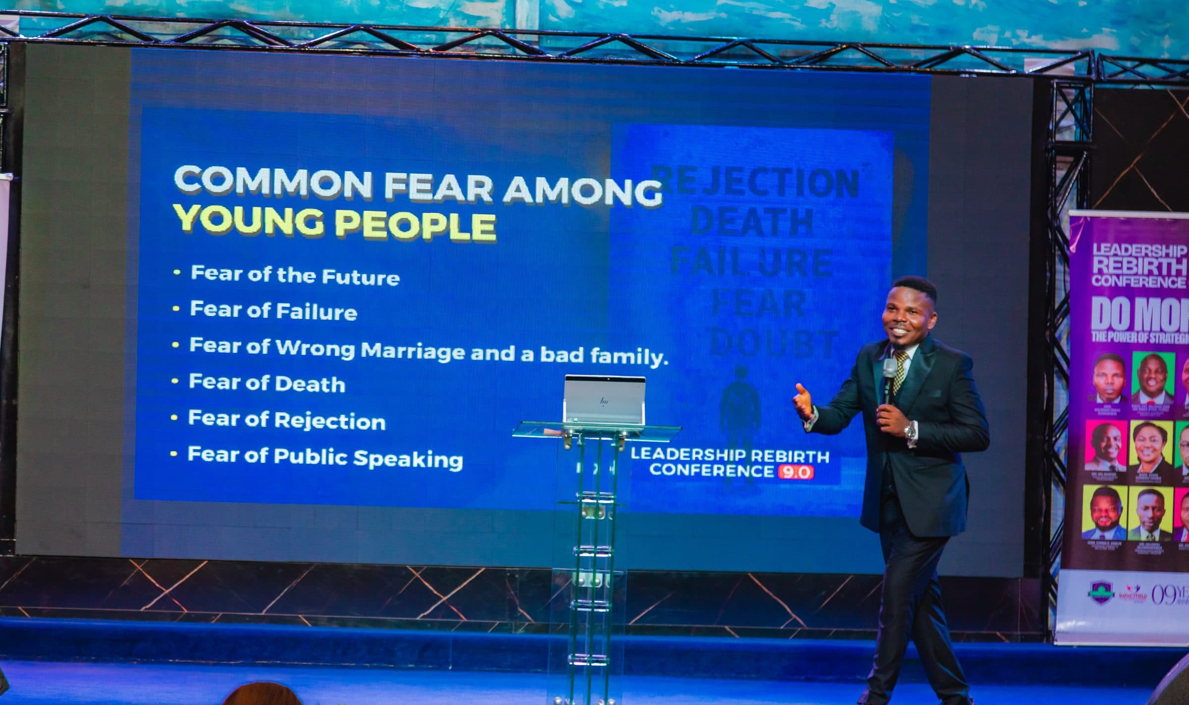 A speaker addressing delegates from the main stage at a Leadership Rebirth Conference