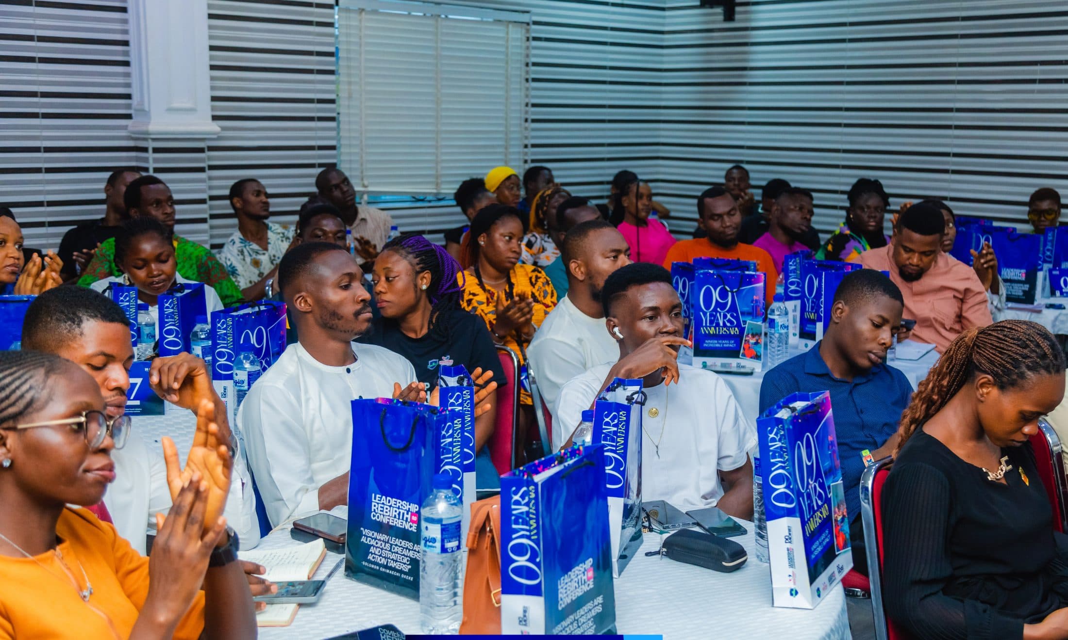 Delegates applauding at their tables during a Leadership Rebirth Conference